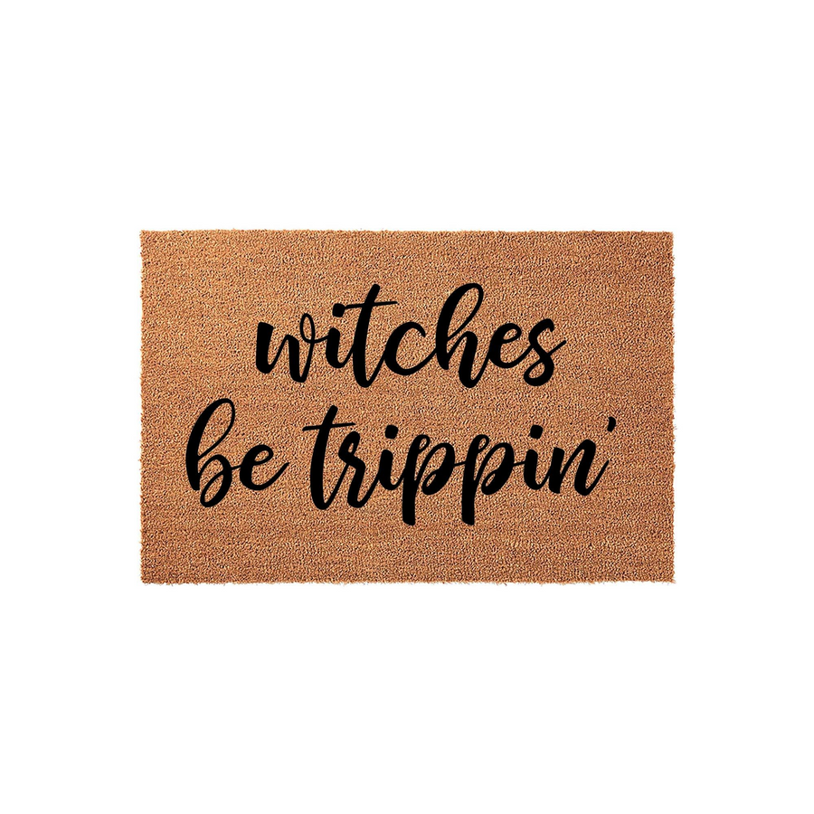 Witches Be Trippin Halloween Doormat featuring a natural coir fiber texture with bold black script lettering, providing a fun and festive seasonal welcome for your front porch entryway during the spooky autumn holiday season.