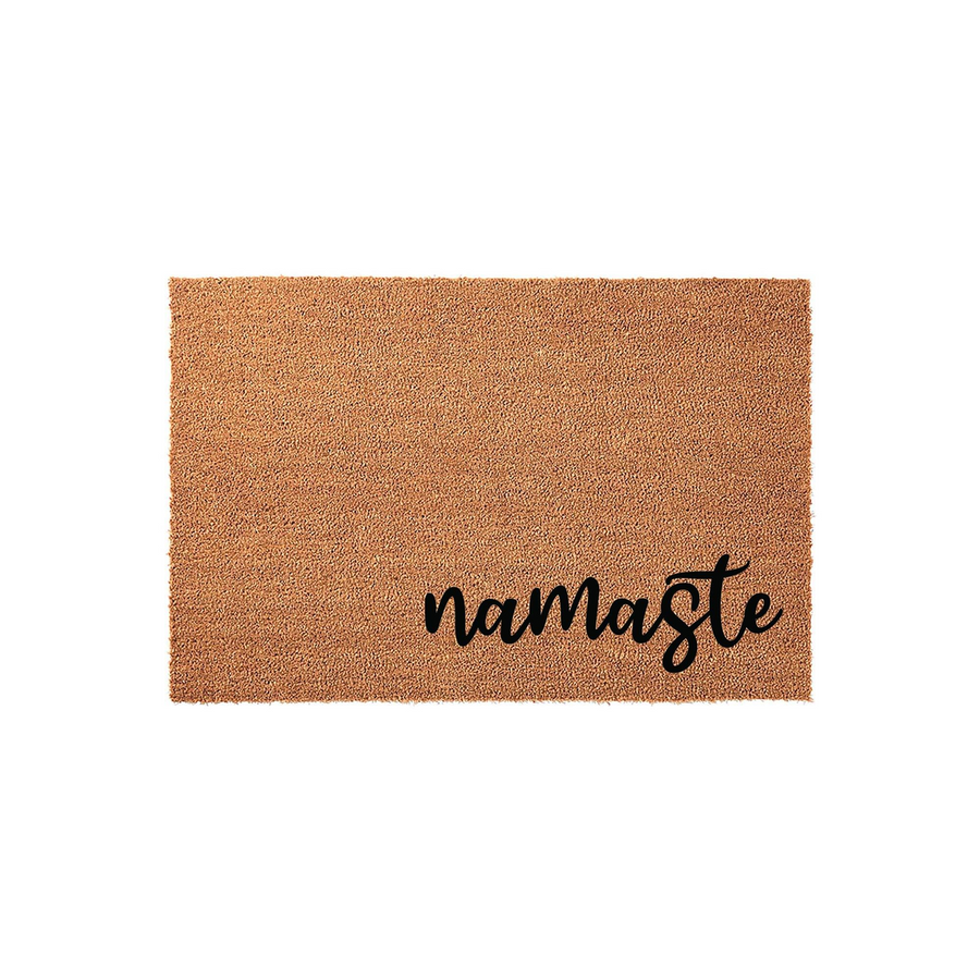 Namaste coir doormat featuring a natural brown fiber texture and elegant black script lettering, providing a welcoming and peaceful aesthetic for your front porch entryway or home decor in a simple, clean studio product shot.