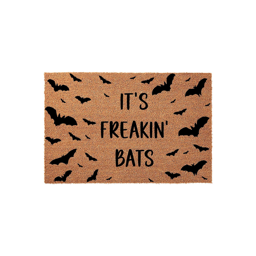 It's Freakin' Bats Halloween doormat featuring a natural coir texture with black printed silhouettes of flying bats scattered across the surface, creating a fun and spooky entryway decor piece for the autumn holiday season.