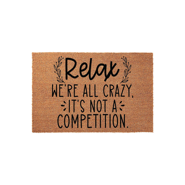 Relax We're All Crazy It's Not A Competition coir doormat featuring a humorous quote in black typography on a natural brown fiber background, designed to add a fun and welcoming touch to your front porch or entryway decor.