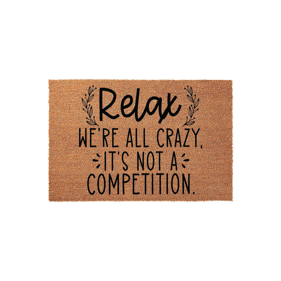 Relax We're All Crazy It's Not A Competition coir doormat featuring a humorous quote in black typography on a natural brown fiber background, designed to add a fun and welcoming touch to your front porch or entryway decor.