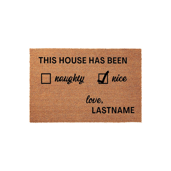 Personalized Christmas doormat featuring a festive naughty or nice checklist design on natural coir fiber, with the text This House Has Been and a space for a custom family name to be printed in bold black lettering on a white