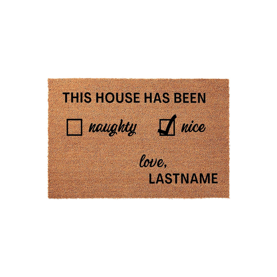 Personalized Christmas doormat featuring a festive naughty or nice checklist design on natural coir fiber, with the text This House Has Been and a space for a custom family name to be printed in bold black lettering on a white