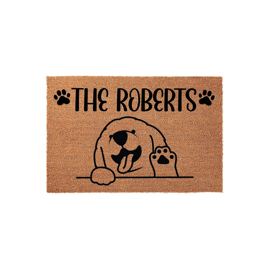 Personalized Golden Retriever family doormat featuring a cute illustrated dog waving hello, with a natural coir texture and black text that allows for a custom family name to be printed above the friendly puppy design.