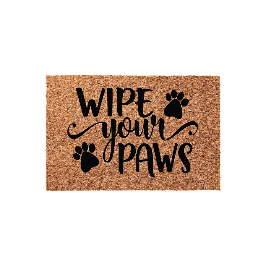 Wipe Your Paws coir doormat featuring black text and cute paw print accents on a natural tan fiber background, creating a charming and functional entryway decor piece for any pet lover's home on a clean white studio backdrop.