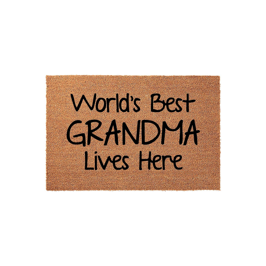 World's Best Grandma Lives Here coir doormat featuring bold black lettering on a natural brown fiber background, creating a cheerful and welcoming entrance piece for any grandmother's home on a clean white studio backdrop.