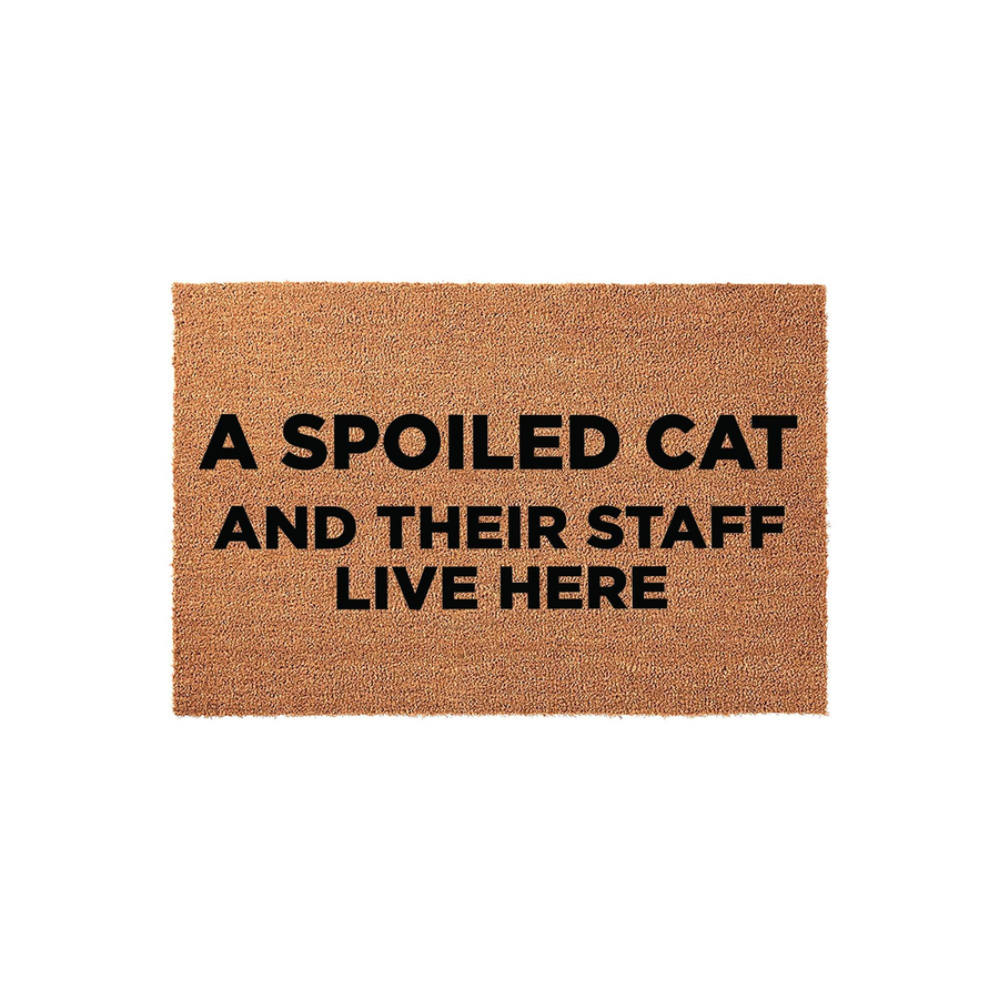 Spoiled Cat Welcome Doormat featuring a natural coir texture with bold black text that reads A SPOILED CAT AND THEIR STAFF LIVE HERE, making it a funny and functional front porch decor piece for any cat lover's home entrance.