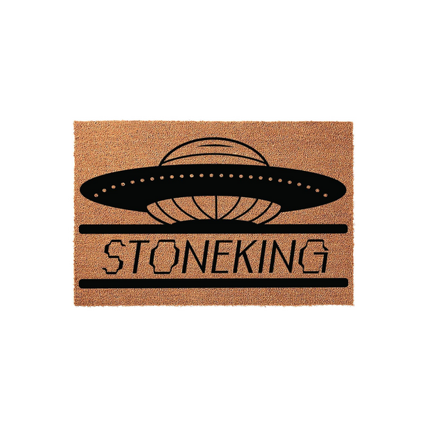 Personalized UFO space themed doormat featuring a black flying saucer graphic above a custom family name text area, printed on a natural tan coir fiber mat that adds a fun sci-fi touch to any front porch or entryway home decor.