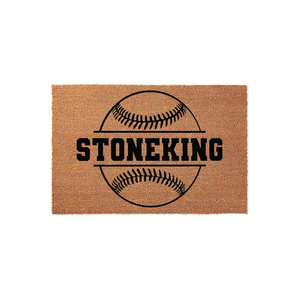 Personalized baseball doormat featuring a large black graphic of a baseball with a central horizontal line for a custom family name, set against a natural tan coir fiber background for a sporty and welcoming front porch entrance.