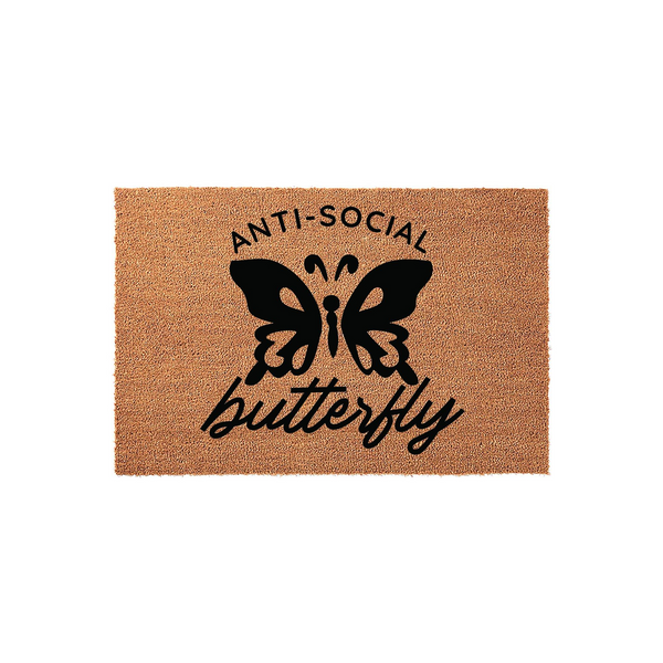 Anti-Social Butterfly Coir Doormat featuring a bold black graphic of a butterfly centered on a natural brown textured fiber background, with the text Anti-Social printed above and the word butterfly written in a cursive script