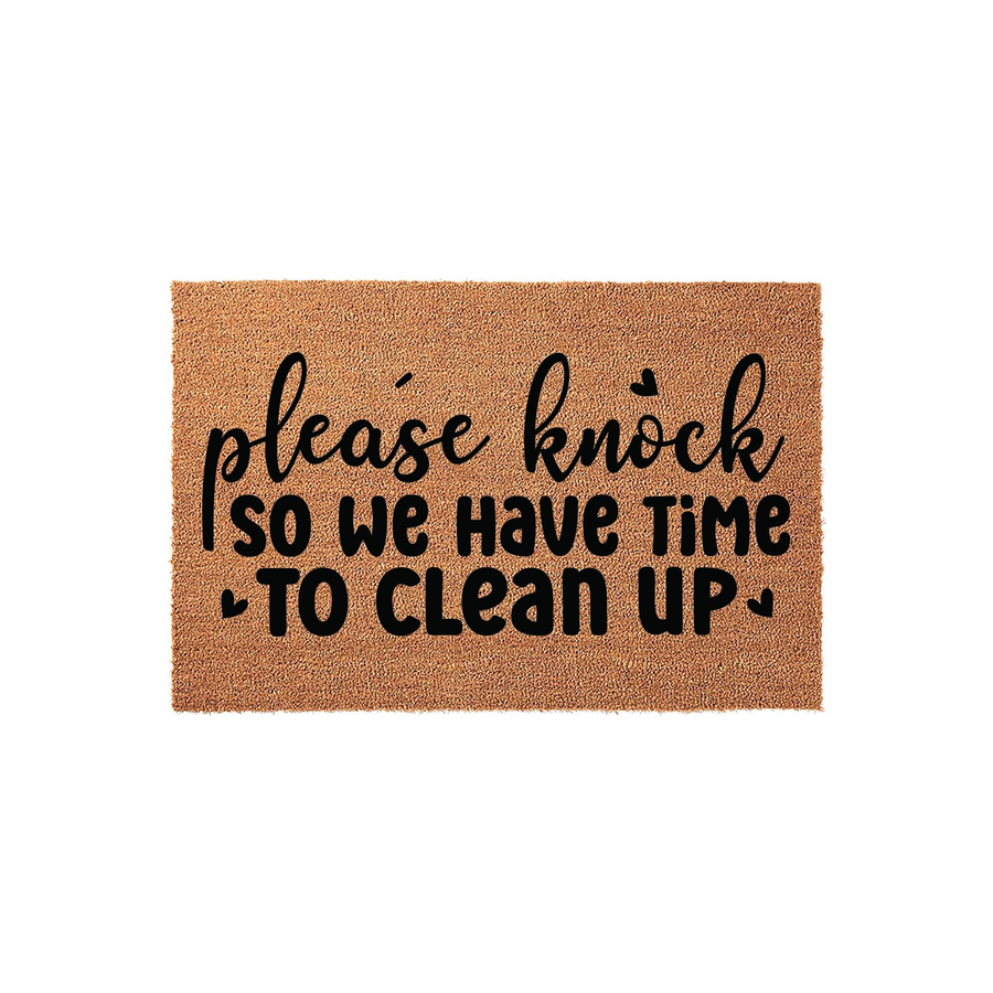 Funny Please Knock Doormat featuring a natural coir texture and bold black lettering that reads please knock so we have time to clean up, making it a humorous and welcoming front porch decor piece for any home entrance or