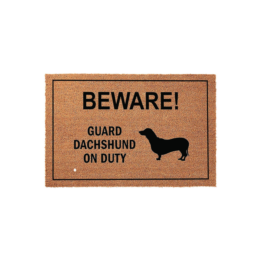 Dachshund Guard Dog Doormat featuring a natural coir texture with a black border and bold text that reads BEWARE! GUARD DACHSHUND ON DUTY, accompanied by a silhouette of a dachshund dog on a plain white studio background.