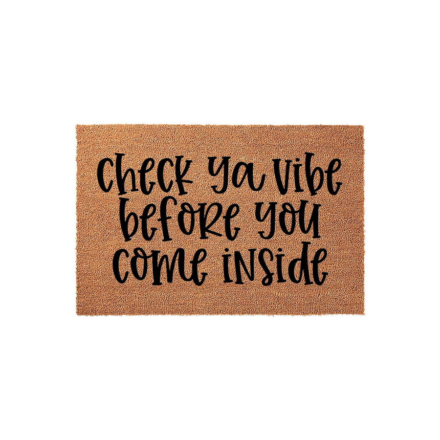 Check Ya Vibe Before You Come Inside doormat featuring a natural brown coir texture with bold black script lettering, providing a fun and welcoming entrance decor piece for your front porch or home entryway on a clean white