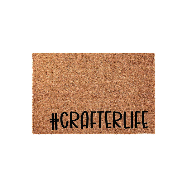 Crafterlife coir doormat featuring a natural brown fiber texture and bold black lettering that reads #CRAFTERLIFE, displayed against a clean white background for a modern and functional home entryway decor piece.