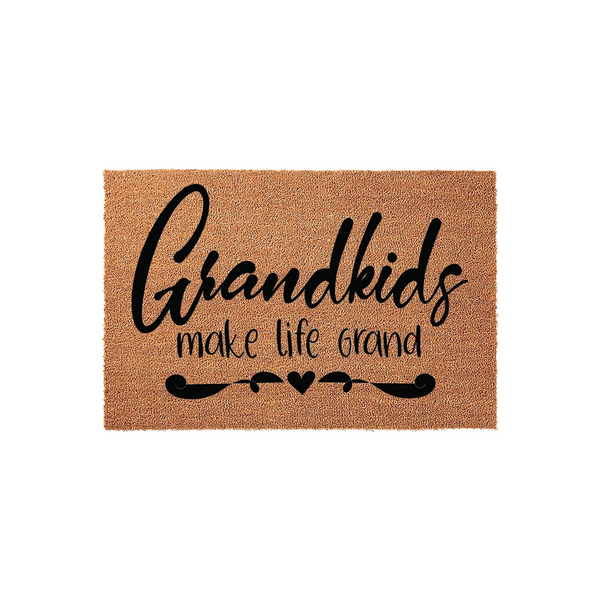 Grandkids Make Life Grand coir doormat featuring bold black script lettering on a natural tan fiber background, accented with a decorative flourish and a small heart design for a welcoming entryway decor piece.