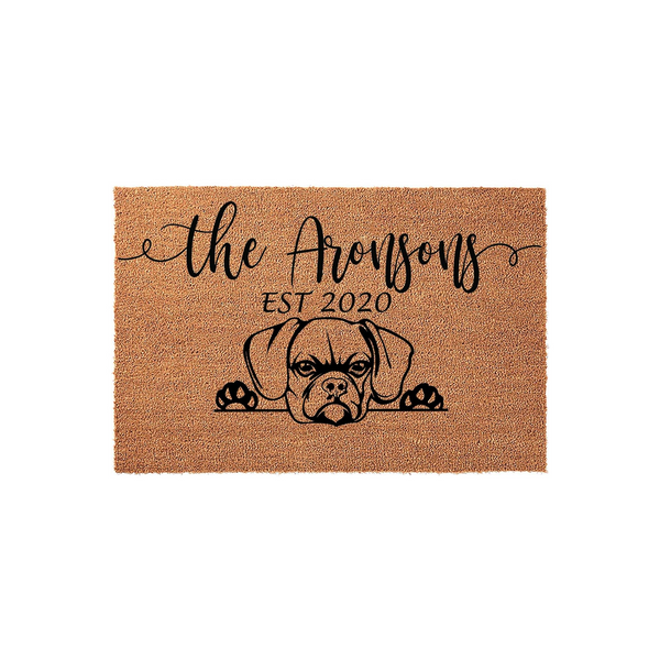 Personalized Boxer dog doormat featuring a cute illustration of a Boxer peeking over the bottom edge, with custom family name text and established year printed in black ink on a natural tan coir fiber welcome mat background.