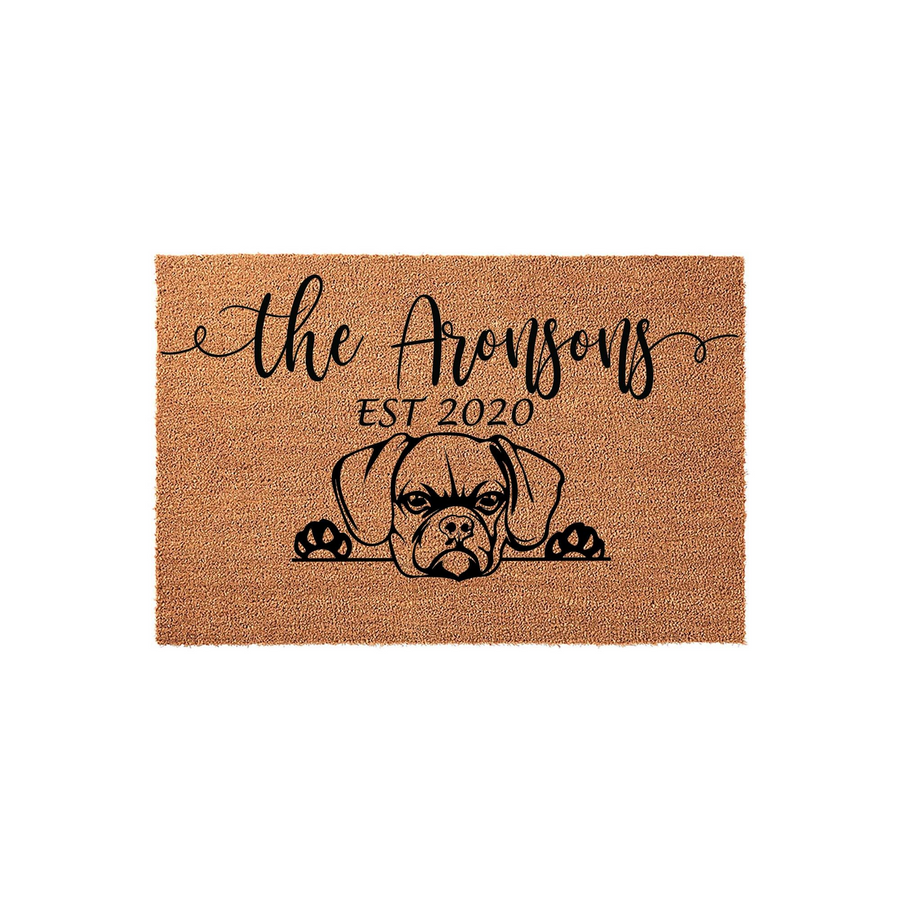 Personalized Boxer dog doormat featuring a cute illustration of a Boxer peeking over the bottom edge, with custom family name text and established year printed in black ink on a natural tan coir fiber welcome mat background.