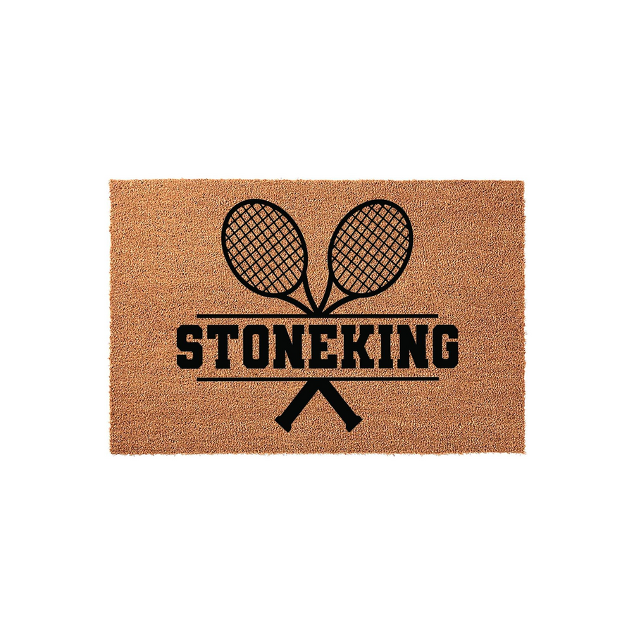 Tennis Themed Personalized Coir Doormat featuring a black graphic of two crossed tennis rackets above a custom family name, set against a natural brown textured fiber background for a sporty and welcoming front porch entrance