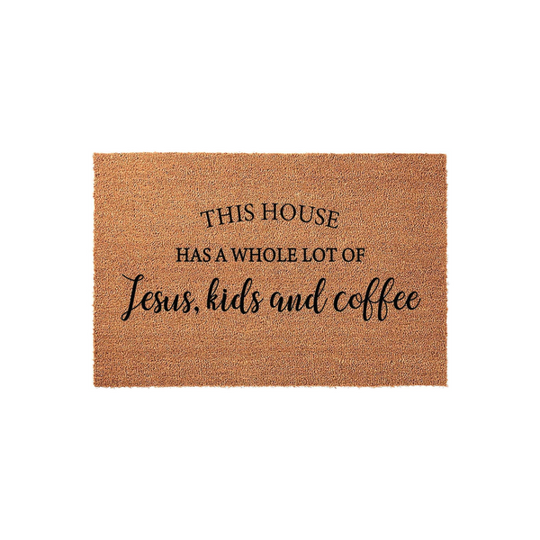 This House Has A Whole Lot Of Jesus, Kids And Coffee coir doormat features a natural tan fiber texture with bold black lettering, creating a welcoming and humorous front porch decor piece for a busy family home on a plain white