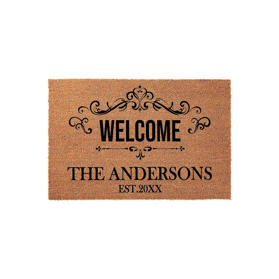 Personalized family name coir doormat featuring a classic black scrollwork design above the word Welcome and a custom established date, set against a natural tan textured fiber background for a welcoming front porch entrance.