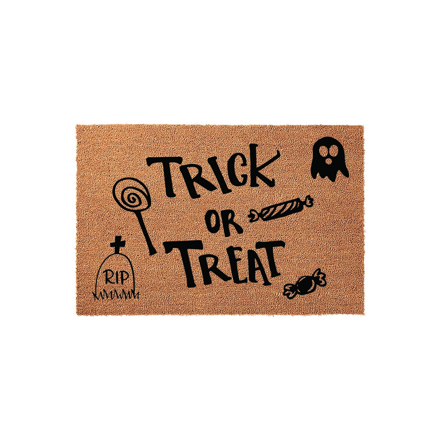 Trick or Treat Halloween doormat made of natural coir fiber, featuring black printed text and spooky holiday icons like a ghost, a tombstone, and various candies on a plain white background for a festive seasonal entryway