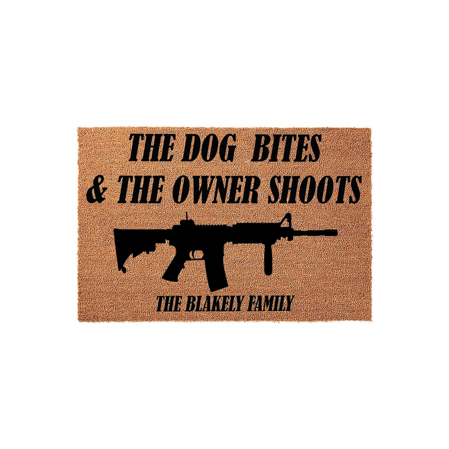 Personalized funny doormat featuring a rifle graphic and the text The Dog Bites and The Owner Shoots, customized with a family name on a natural coir fiber mat that provides a humorous and protective welcome for any home entrance.
