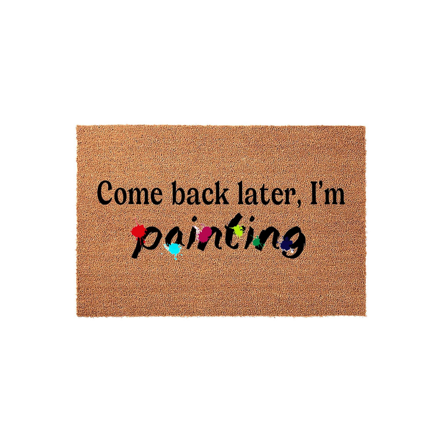 Come back later I am painting coir doormat featuring a natural brown fiber texture with black text and colorful paint splatter accents on the word painting, displayed against a clean white background for a fun home entryway decor