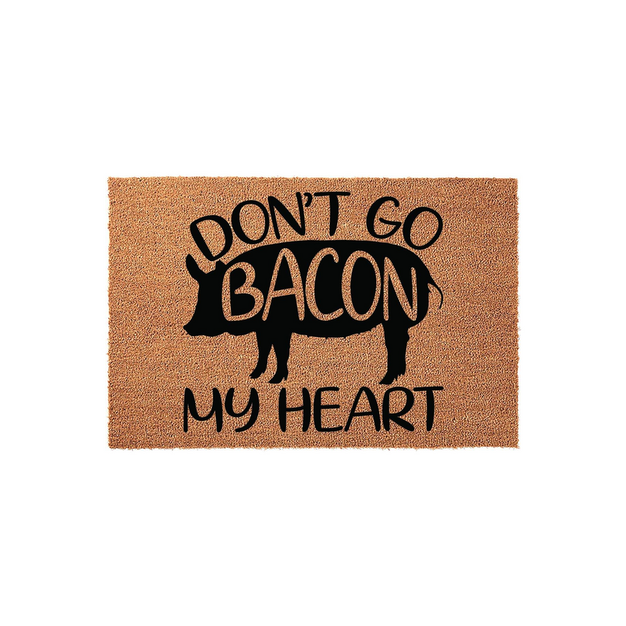 Funny Pig Doormat featuring a silhouette of a pig with the text Don't Go Bacon My Heart printed in bold black lettering on a natural tan coir fiber background, creating a humorous and welcoming entrance for any farmhouse style