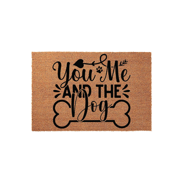 You Me and the Dog coir doormat featuring black text and a bone graphic on a natural tan fiber background, creating a charming entryway accent for pet owners who want to celebrate their furry family members at their front door.