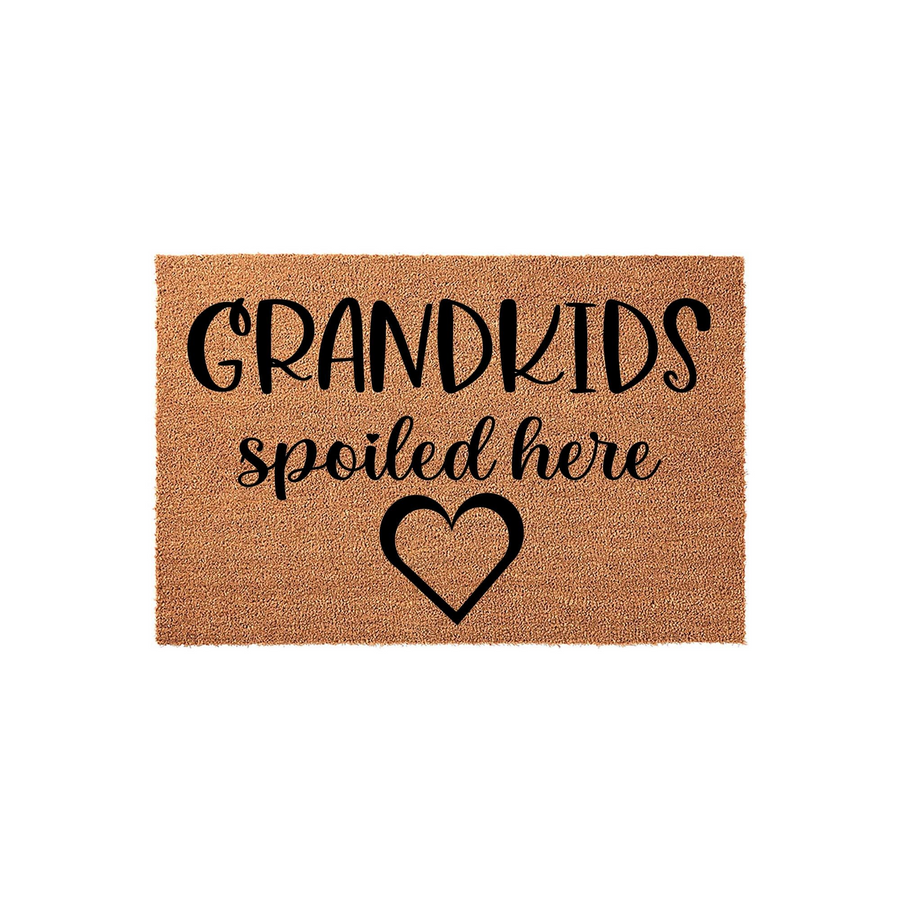 Grandkids Spoiled Here coir doormat featuring bold black typography and a simple heart icon centered on a natural brown textured fiber background, creating a welcoming entrance for any home with visiting grandchildren.