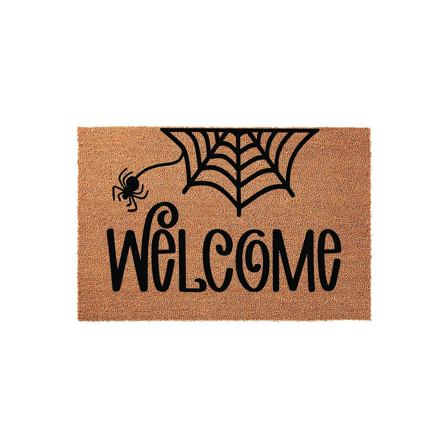 Halloween Welcome Doormat featuring a natural coir texture with a black spider and web design printed above the word Welcome in a decorative script font, creating a festive spooky entryway decor piece for the fall season.