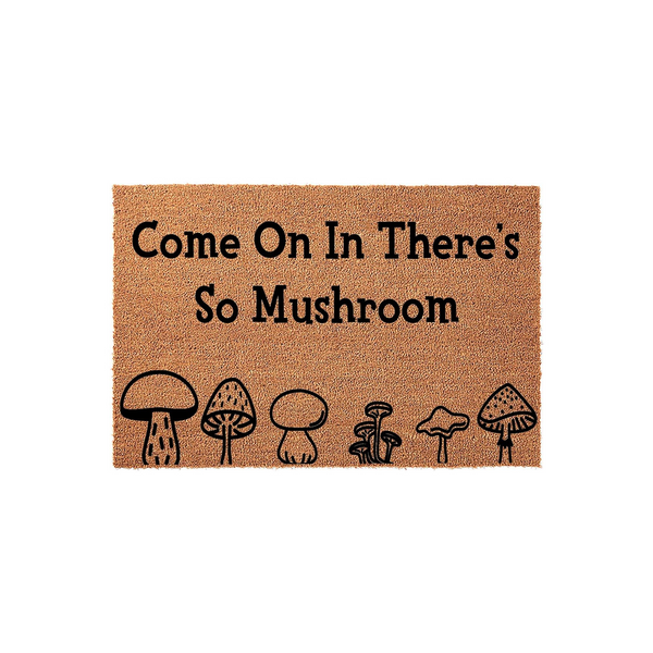 Mushroom Welcome Doormat featuring a natural coir texture with the playful pun text Come On In There's So Mushroom printed in black, accompanied by a row of six unique hand-drawn style mushroom illustrations along the bottom edge.