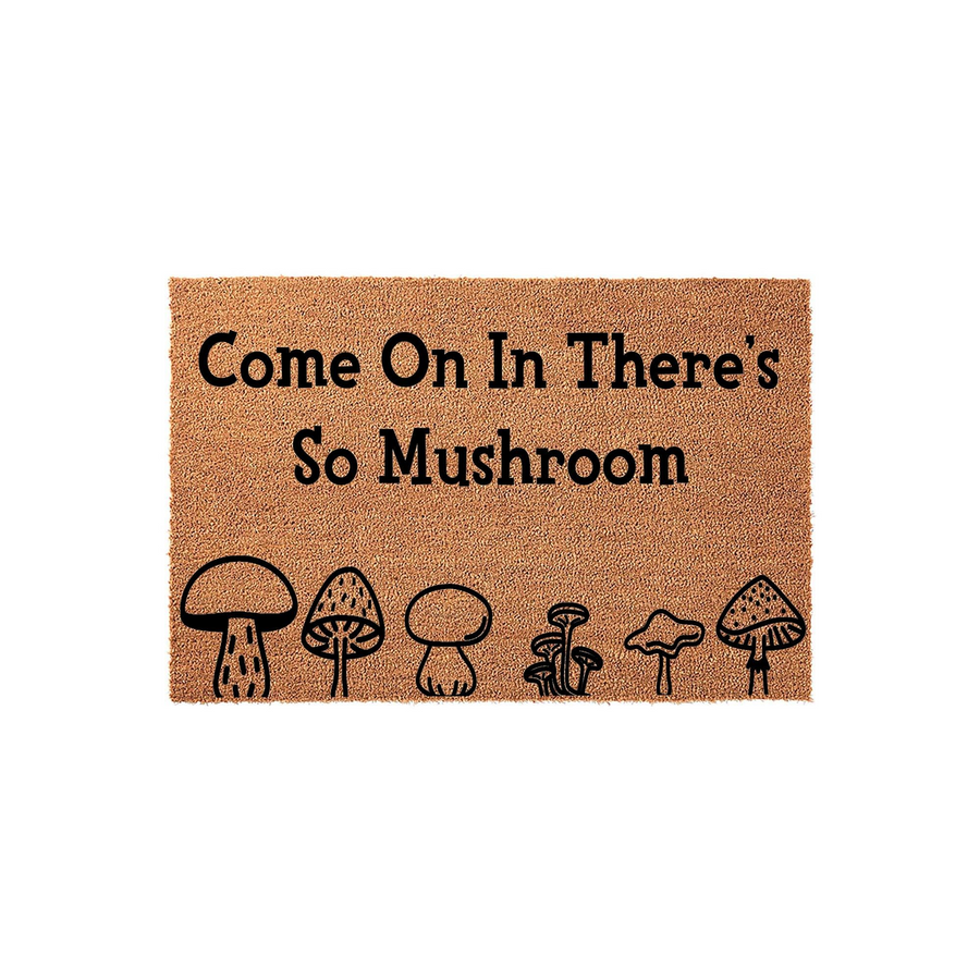 Mushroom Welcome Doormat featuring a natural coir texture with the playful pun text Come On In There's So Mushroom printed in black, accompanied by a row of six unique hand-drawn style mushroom illustrations along the bottom edge.