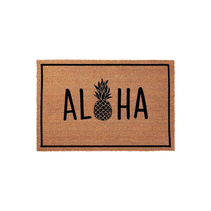 Aloha Pineapple Coir Doormat featuring a natural tan fiber texture with a black border and the word Aloha printed in bold black letters, where the letter O is replaced by a stylized black pineapple icon on a clean white