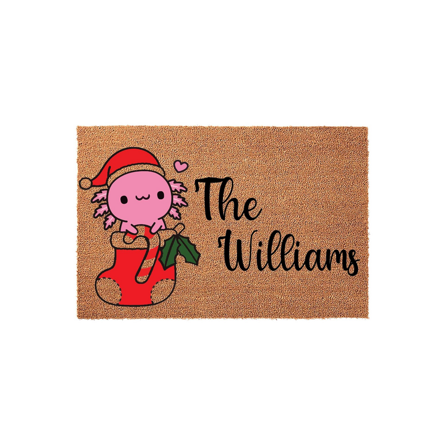 Personalized Axolotl Christmas Doormat featuring a cute pink axolotl wearing a Santa hat while sitting in a red stocking, with custom family name text printed in black script on a natural coir fiber background for holiday decor.