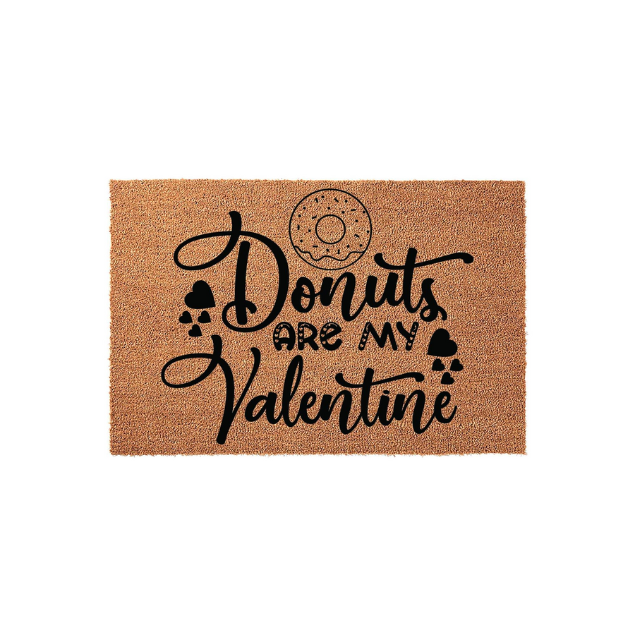 Donuts Are My Valentine coir doormat featuring a natural brown fiber texture with black printed text and a donut graphic, creating a fun and festive entryway decor piece for the holiday season on a clean white studio background.