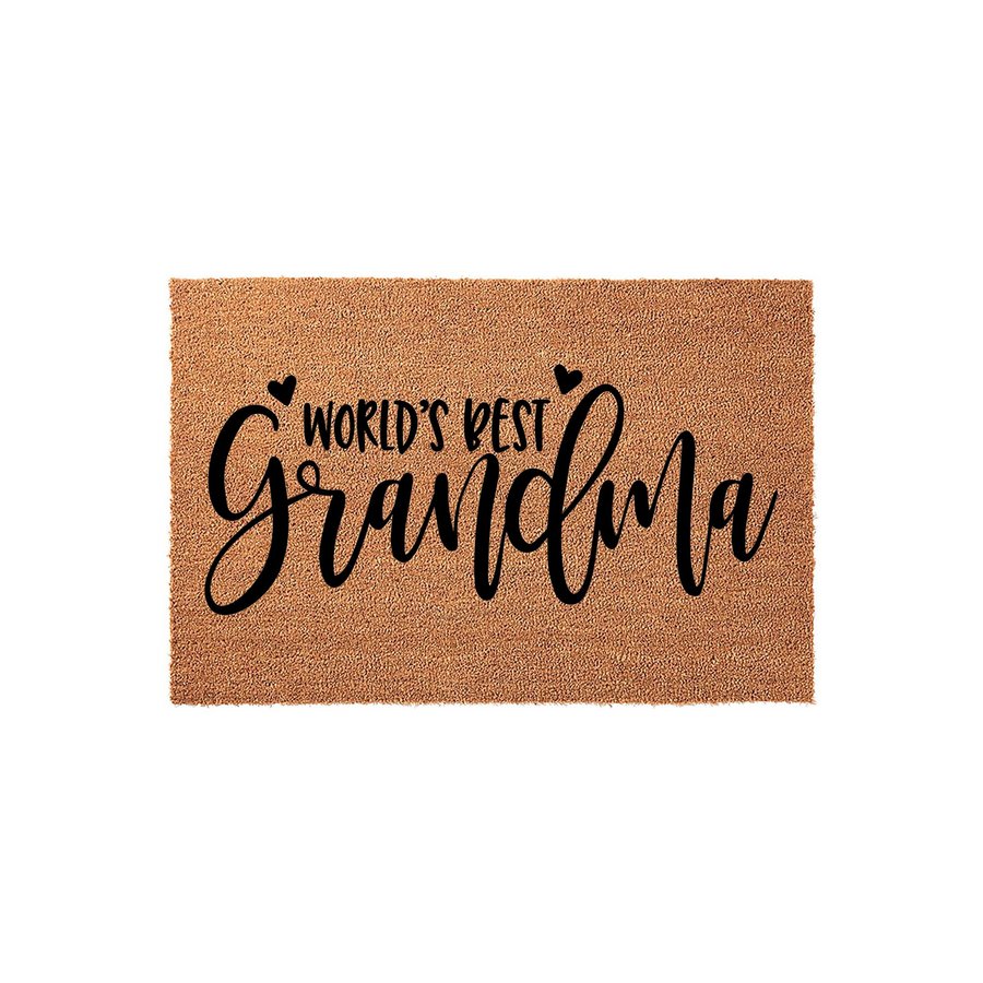 World's Best Grandma coir doormat featuring natural brown coconut fiber texture and bold black script lettering, accented with two small hearts above the text, displayed against a clean white studio background for a welcoming