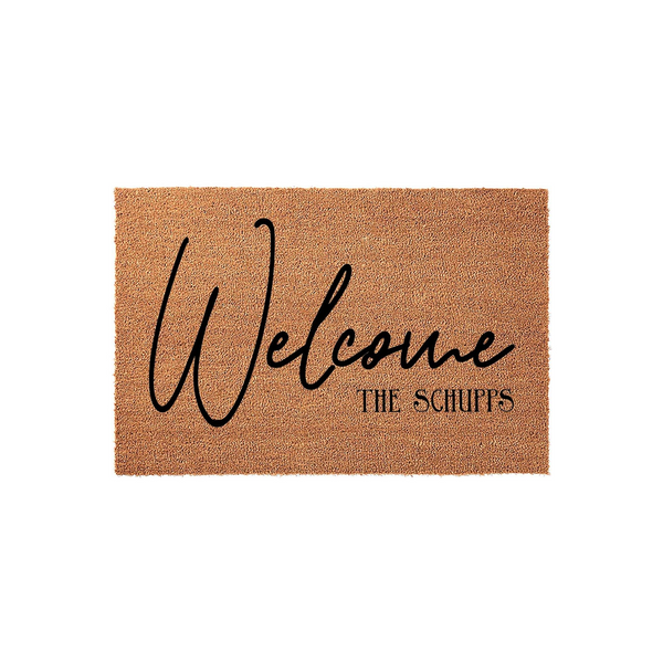 Personalized coir welcome doormat featuring a natural tan fiber texture with the word Welcome written in a large black script font and a custom family name printed underneath in a clean, modern serif typeface on a plain white