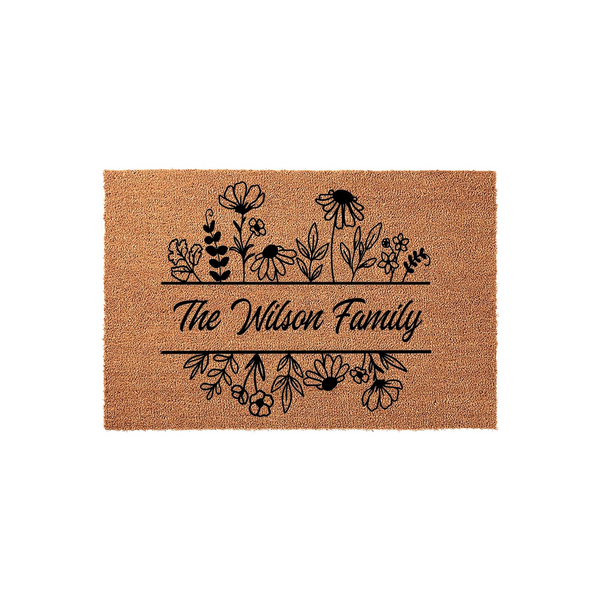 Personalized floral family name doormat featuring a natural coir texture with a black ink design of wildflowers and a custom last name centered between horizontal lines, creating a welcoming entryway decor piece for any modern