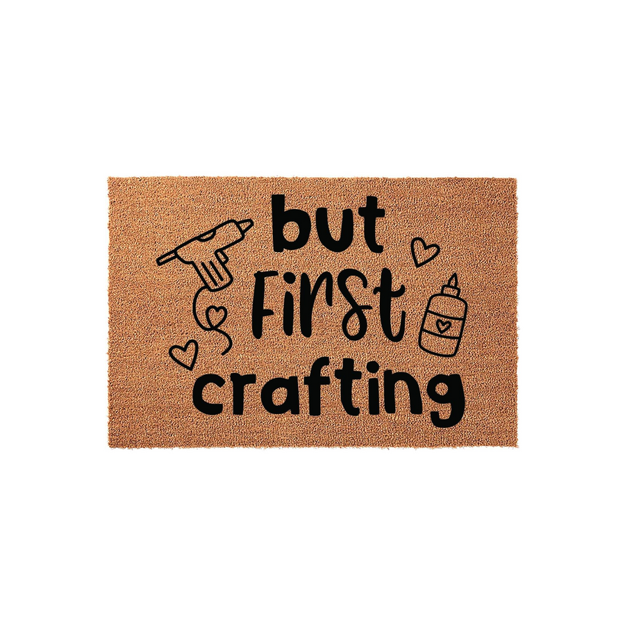 But First Crafting coir doormat featuring a natural brown fiber texture with black printed text and cute illustrations of a glue gun and glue bottle, making it a fun entryway decor piece for any dedicated hobby room or craft