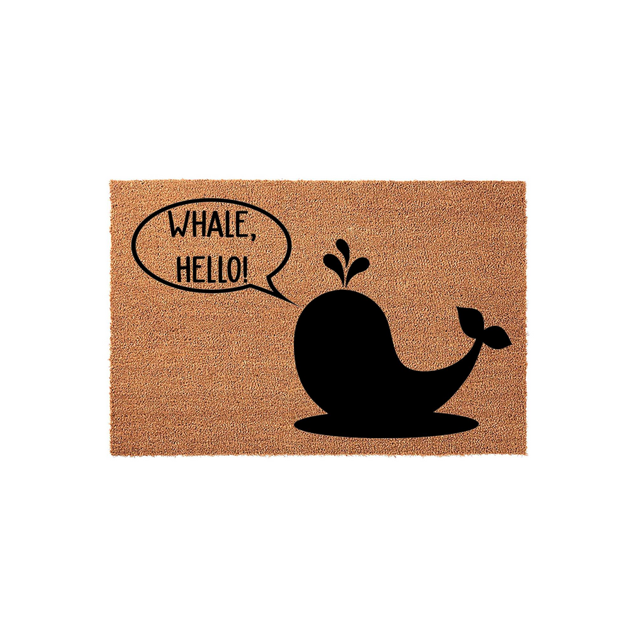 Whale Hello doormat made of natural coir fiber featuring a black silhouette of a cute whale with a speech bubble that says Whale Hello, providing a fun and nautical welcome for your front porch or entryway decor in a clean studio
