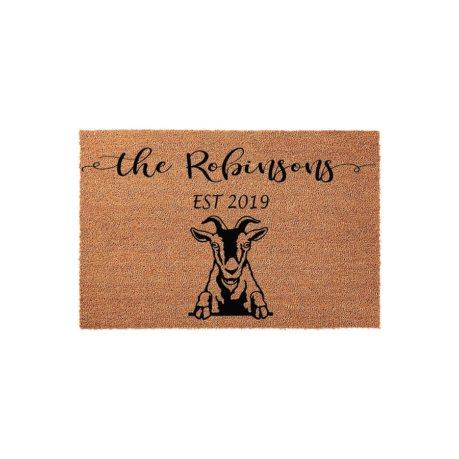 Personalized Goat Welcome Doormat featuring a rustic coir texture with a black graphic of a goat peeking over the bottom edge, customized with a family name and established year in elegant black script and serif fonts on a plain