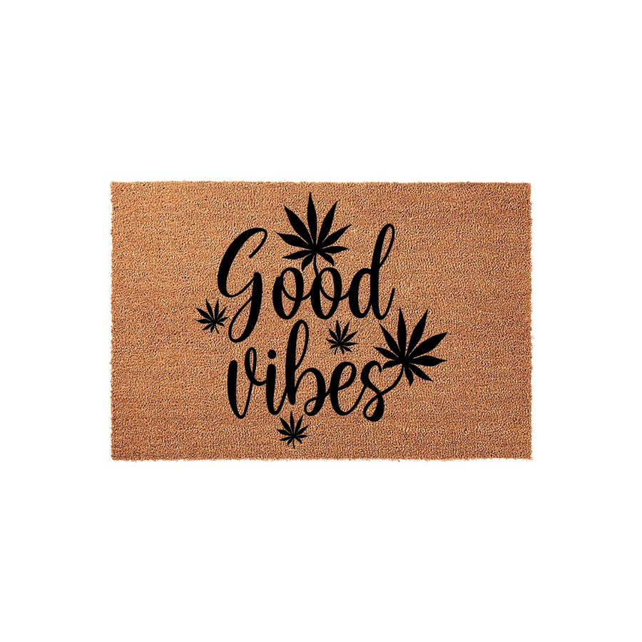 Good Vibes coir doormat featuring a natural brown fiber texture and bold black script lettering, accented with stylized cannabis leaf icons for a fun, relaxed entryway decor piece that welcomes guests to your home with a positive