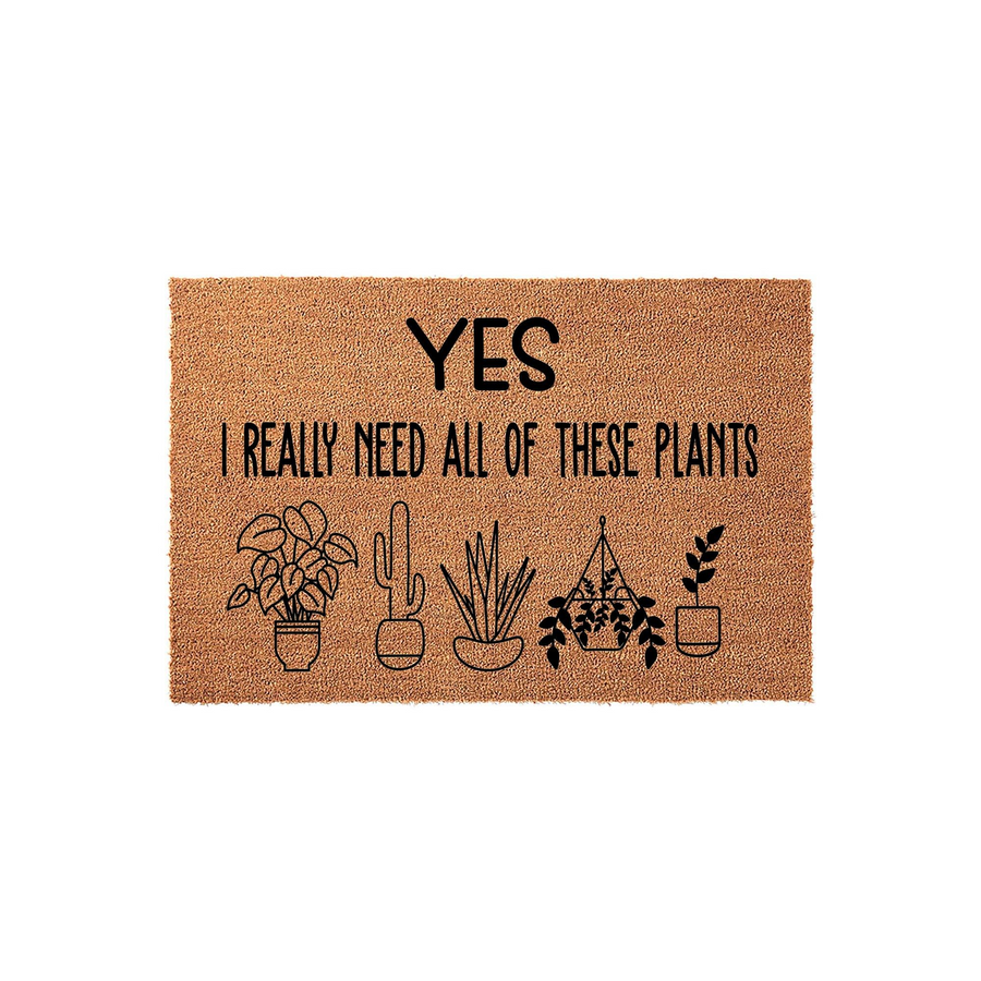 Yes I Really Need All Of These Plants doormat featuring a natural coir texture with black printed text and a row of five different potted plant illustrations, making it a fun outdoor welcome mat for any indoor plant lover.