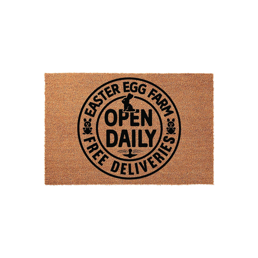 Easter Egg Farm Doormat featuring a circular black design on a natural coir background, with a bunny silhouette and the text Open Daily Free Deliveries printed in the center for a festive spring home decor entrance.
