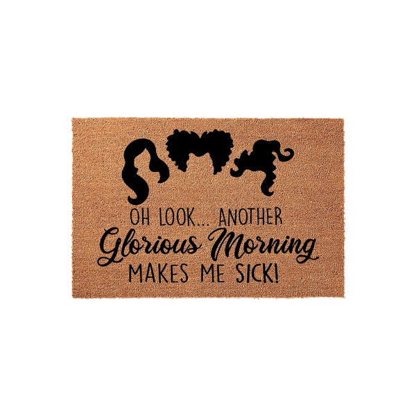 Hocus Pocus inspired coir doormat featuring the iconic silhouettes of the three Sanderson sisters above the text Oh Look Another Glorious Morning Makes Me Sick, perfect for a spooky Halloween front porch decor setup on a plain