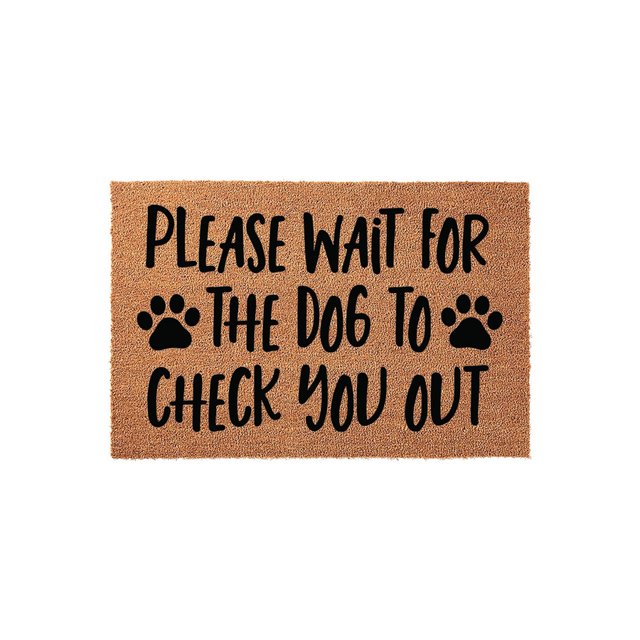 Dog Lover Welcome Doormat featuring a natural coir texture with bold black text that reads Please Wait For The Dog To Check You Out, accented by two paw prints on a simple white background for a fun and functional home entryway