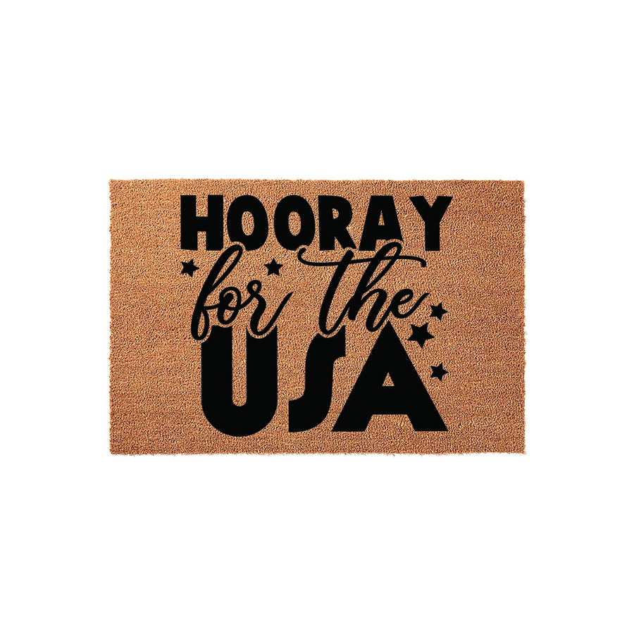 Hooray for the USA coir doormat featuring bold black text and decorative stars on a natural brown fiber background, creating a festive patriotic entrance decor piece for your front porch or home entryway during the summer