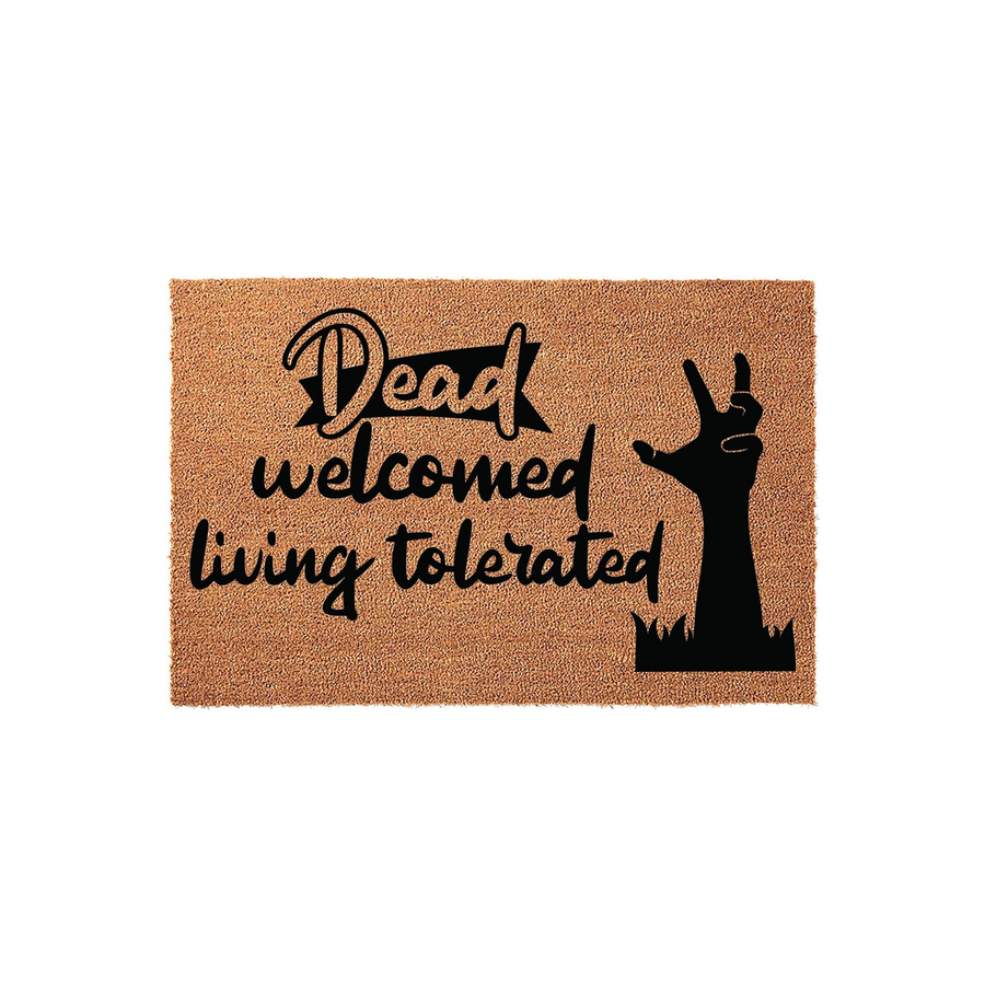 Funny Halloween doormat featuring a spooky zombie hand reaching from the ground with the text Dead welcomed living tolerated, printed in black ink on a natural tan coir fiber mat against a clean white studio background.