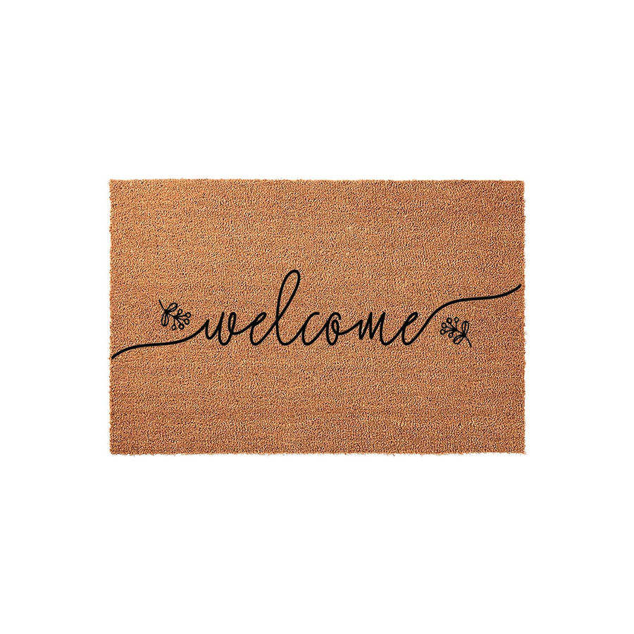 Natural coir welcome doormat featuring elegant black cursive script lettering centered on the mat, accented by delicate floral sprigs on either side of the word welcome, set against a clean white background for a modern farmhouse
